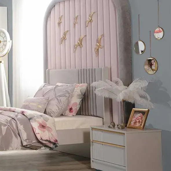 Elegant nightstand beside luxurious bed with upholstered headboard and floral bedding